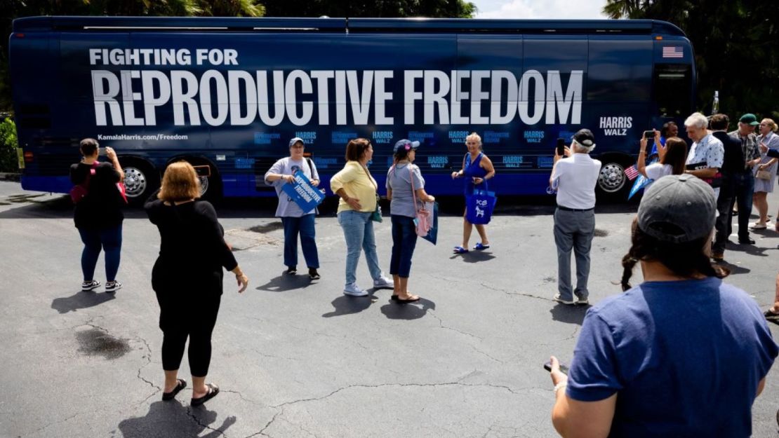 People take photos of the Reproductive Freedom Bus during the kickoff of the Harris-Walz campaign's reproductive rights bus tour in Boynton Beach, Florida, on September 3.