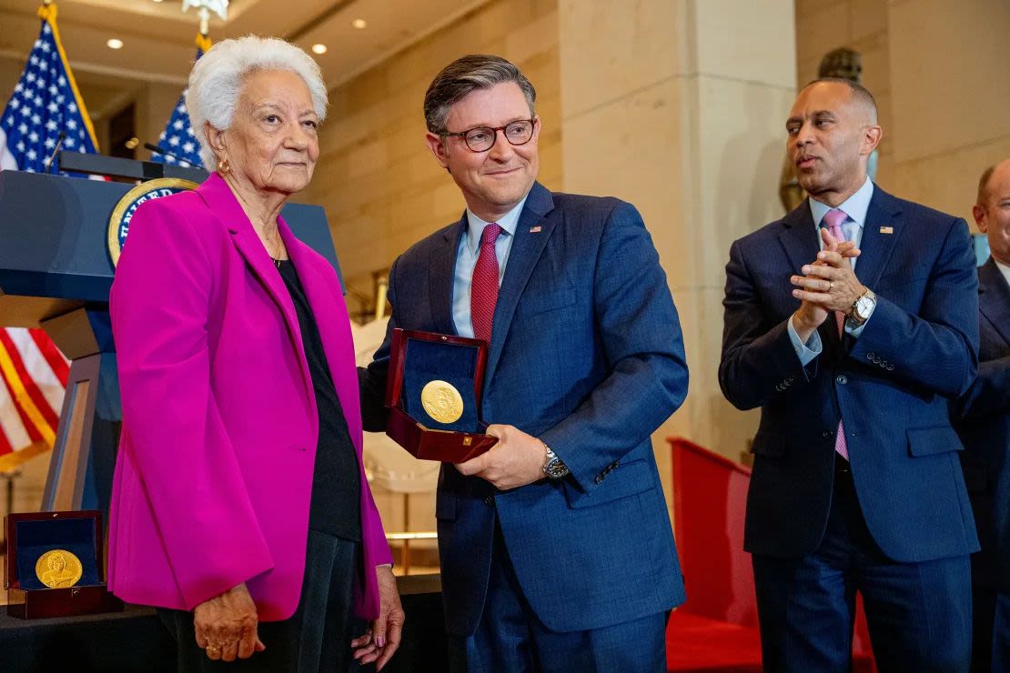 House Minority Leader Hakeem Jeffries (right) applauds as House Speaker Mike Johnson poses with Wanda Jackson (left) while accepting a Congressional Gold Medal on behalf of Mary Jackson during a ceremony at the Capitol on Wednesday.