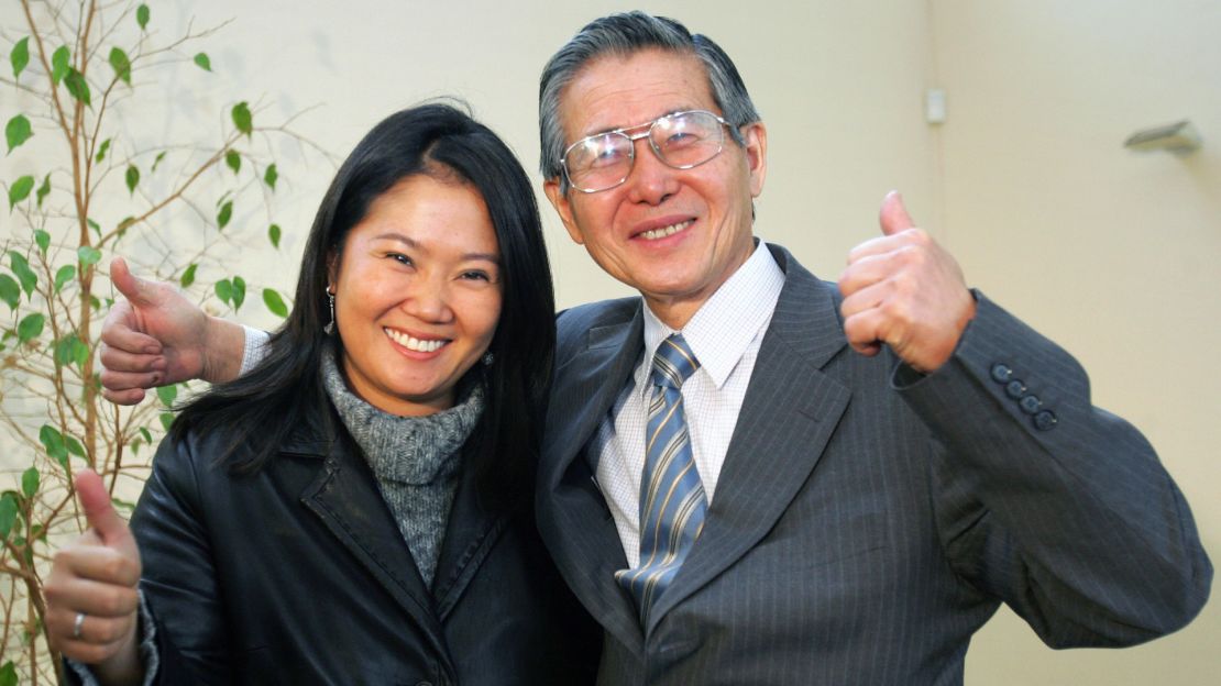 Former president of Peru Alberto Fujimori and his daughter Keiko greet the press at their residence, on May 20, 2006, in Santiago.