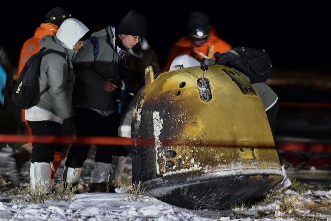 Recovery team members inspect the Chang'e 5 probe after its successful return landing in northern China in December 2020.