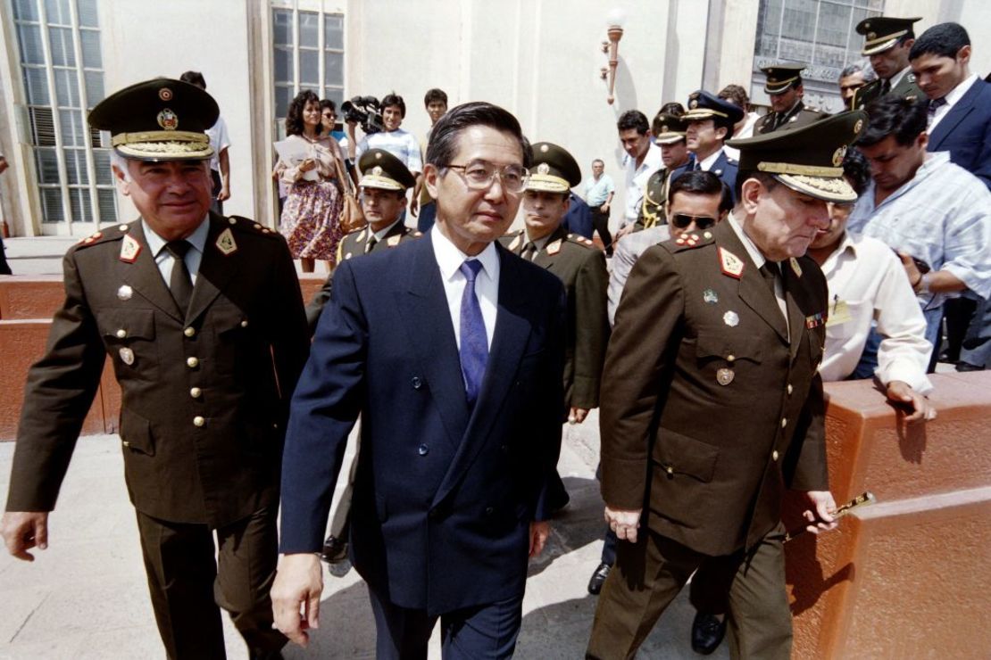 Peruvian President Alberto Fujimori walks with Interior Minister General Víctor Malca (left) and another unidentified member of the armed forces during a visit to a military school on April 24, 1992 in Lima. Credit: HECTOR MATA/AFP via Getty Images