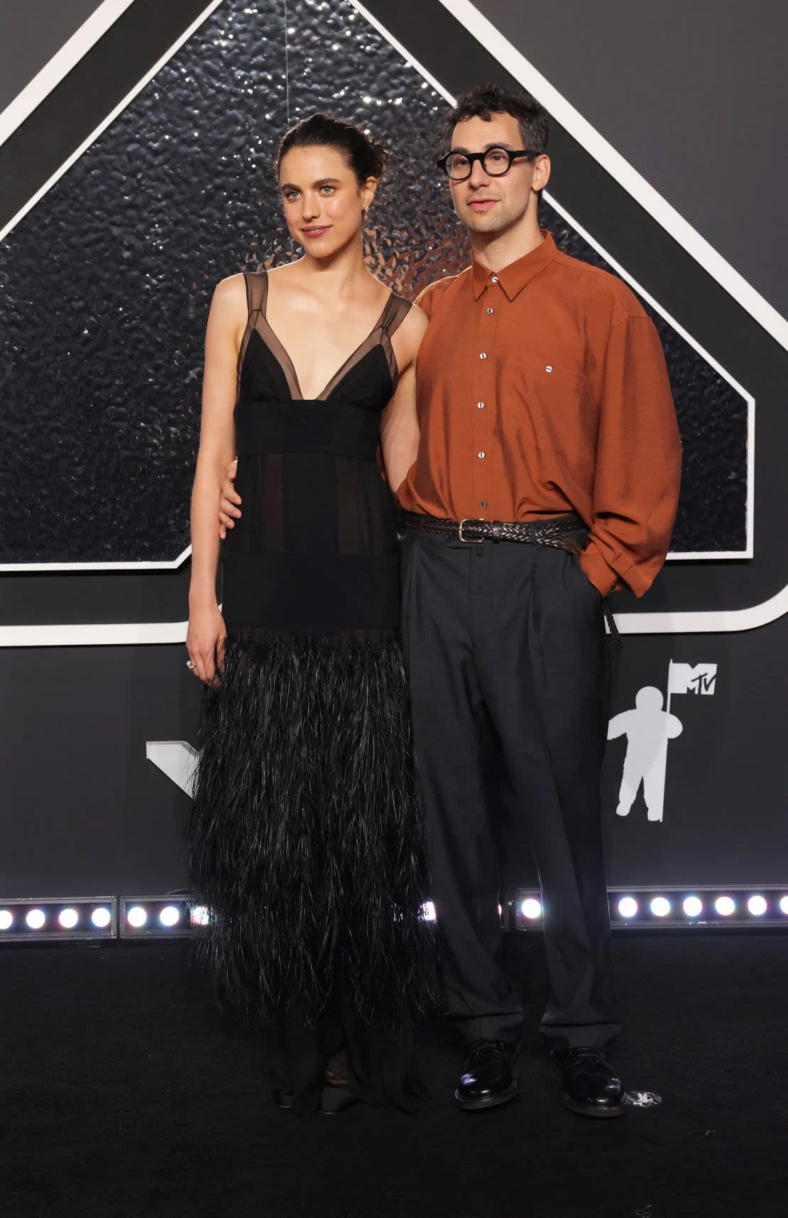 Margaret Qualley, who posed with her husband Jack Antonoff, wore a feathered black chiffon Chanel dress inspired by a look from the brand's Fall-Winter 1995/96 Haute Couture collection. Credit: Andrew Kelly/Reuters.