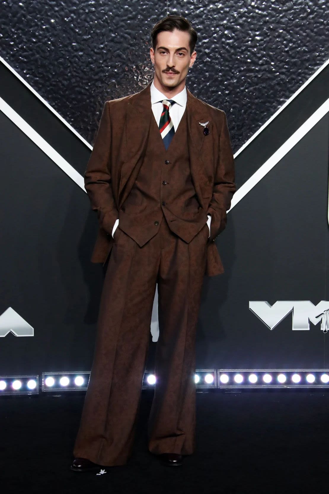 Damiano David from Måneskin wore a three-piece jacquard suit, with wide pants and peak lapels, from the Italian brand Etro. Credit: Matt Baron/EIB/Shutterstock.