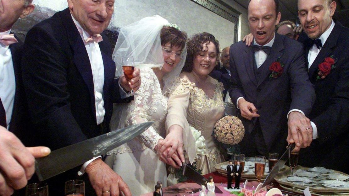 Homosexual couples cut a wedding cake in Amsterdam on April 1, 2001, after the first same-sex marriage law was passed in the Netherlands.