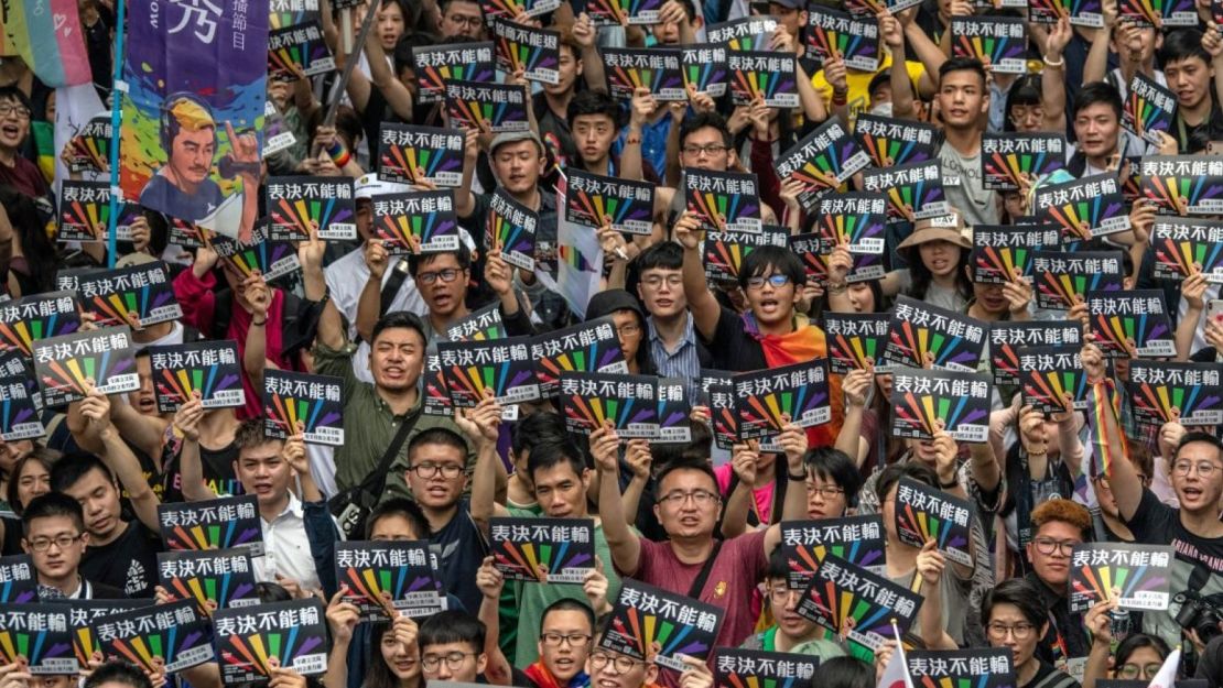 People hold signs as they gather outside Taiwan's parliament ahead of a vote on legalizing same-sex marriage on May 17, 2019 in Taipei, Taiwan.