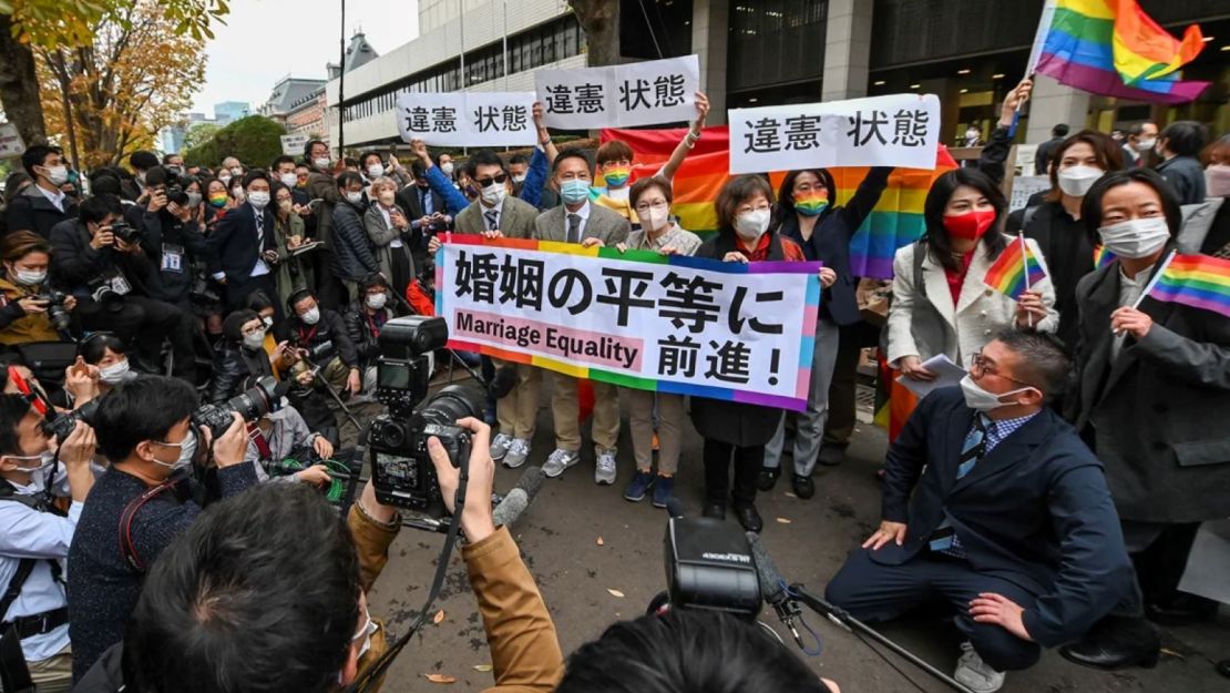 Plaintiffs and supporters react outside the Tokyo District Court on Nov. 30, 2022, following a ruling in a lawsuit brought by same-sex couples seeking compensation from the government.